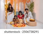 Indian festival background, South Indian people wearing traditional dress and arranging Onam pookalam, Onam and Diwali festival photo