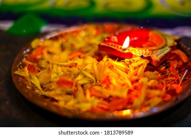 Indian Festival Diwali , lamp and marigold flower petals in pooja thali - Shutterstock ID 1813789589