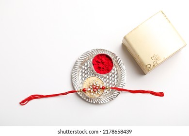 Indian Festival Raksha Bandhan: Rakhi Or Wrist Band Gift Box On White Background.