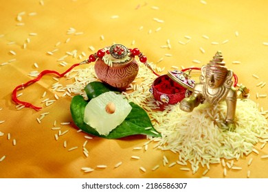 Indian festival: Raksha Bandhan. A traditional Indian wrist band on yellow background.