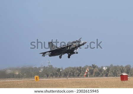 Indian fighter jet in sky maneuver.Landing with parachute