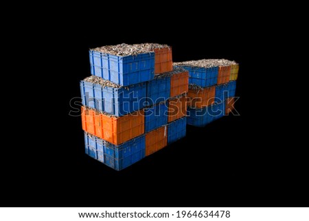 Indian fish export containers tower isolated on black background.