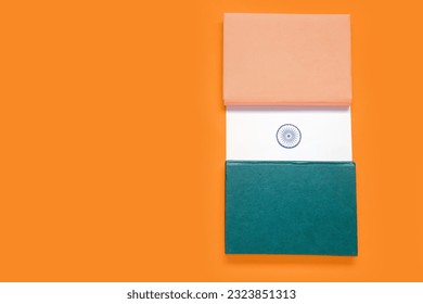 Indian flag made of books on orange background - Powered by Shutterstock