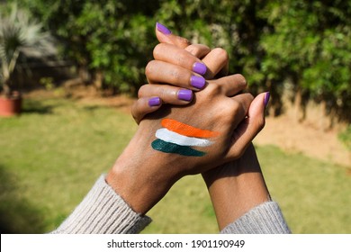 Indian flag tattoo of tri colour painted on person's hand cheering and celebrating Indian republic day - Shutterstock ID 1901190949