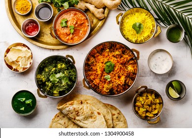 Indian Food Curry Butter Chicken, Palak Paneer, Chiken Tikka, Biryani, Papad, Dal, Rice With Saffron And Naan Bread On White Background