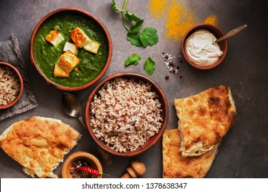 Indian Food Palak Paneer , Naan Bread, Rice And Spices On A Dark Background. Overhead View. Flat Lay.