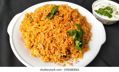 Indian Food Tomato Pulao Rice With Coriander And Mint Leaves On A Plate