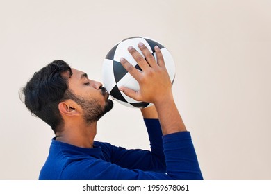  Indian Football player kissing soccer ball