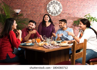 Indian Friends Eating Or Dining In Restaurant. Asian People In Face For Get-together, Reunion Or Celebrating Party. Coffee Shop Celebration Friendship Togetherness Concept