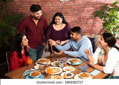 Indian Friends Eating Or Dining In Restaurant. Asian People In Face For Get-together, Reunion Or Celebrating Party. Coffee Shop Celebration Friendship Togetherness Concept