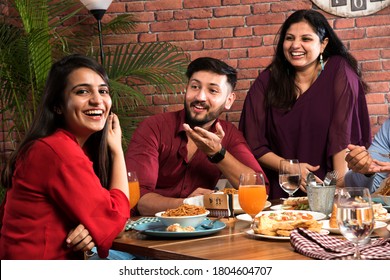 Indian Friends Eating Or Dining In Restaurant. Asian People In Face For Get-together, Reunion Or Celebrating Party. Coffee Shop Celebration Friendship Togetherness Concept