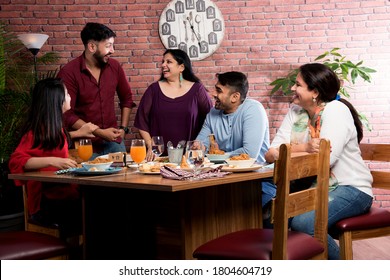 Indian Friends Eating Or Dining In Restaurant. Asian People In Face For Get-together, Reunion Or Celebrating Party. Coffee Shop Celebration Friendship Togetherness Concept