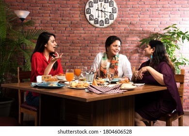 Indian Friends Eating Or Dining In Restaurant. Asian People In Face For Get-together, Reunion Or Celebrating Party. Coffee Shop Celebration Friendship Togetherness Concept