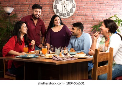 Indian Friends Eating Or Dining In Restaurant. Asian People In Face For Get-together, Reunion Or Celebrating Party. Coffee Shop Celebration Friendship Togetherness Concept