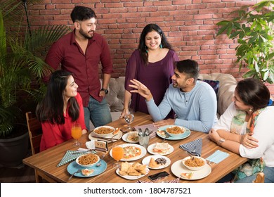 Indian Friends Eating Or Dining In Restaurant. Asian People In Face For Get-together, Reunion Or Celebrating Party. Coffee Shop Celebration Friendship Togetherness Concept