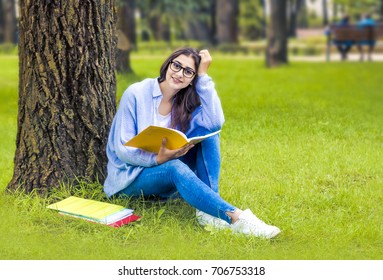 Indian Girl With Books. A Student In A Park Near College.