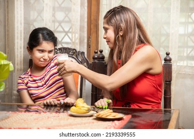 Indian Girl Child Dislike Milk While Her Mother Holding The Glass.