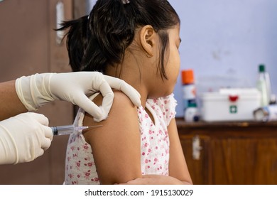 an Indian girl child looking away in fear during vaccination