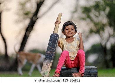 Indian Girl Child Playing Cricket