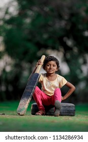 Indian Girl Child Playing Cricket