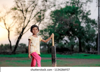 indian girl child playing cricket