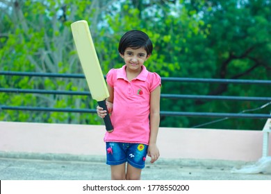 Indian Girl Child Playing Cricket