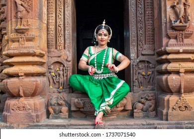 Indian girl dancing classical traditional Indian Odissi dance. Odissi dance is a major ancient Indian traditional dance form originated in the Hindu temples of Odisha.