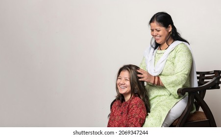 An Indian Girl Getting Her Head Massage By Her Mother, Daughter And Mother Love For Mother's Day Concept.