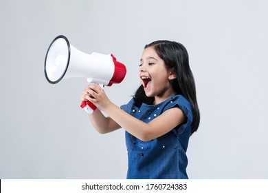 Indian Girl Kid with megaphone shouting on white banner background with copy space