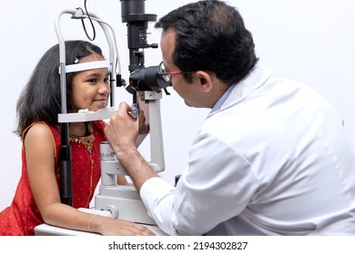 Indian Girl And Optometrist Doing Eye Test With Slit Lamp In Modern Ophthalmology Clinic, Checking Retina Of A Girl Eye