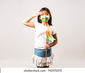 indian girl with paper windmill toy made up of tricolour and face painted with indian flag colours.Suitable for Happy Independence day or Republic day greeting.