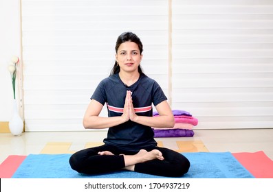An Indian Girl Performing Yoga On The Mat. 