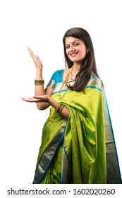 Indian Girl in saree presenting while standing isolated over white background