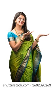 Indian Girl in saree presenting while standing isolated over white background