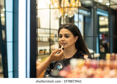 Indian Girl Seeing Mirror And Doing Makeup With Full Of Bokeh