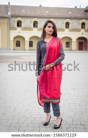An Indian girl stands on the street of the city of Ivano-Frankivsk. Girl in traditional Indian clothing, salwar kameez.
