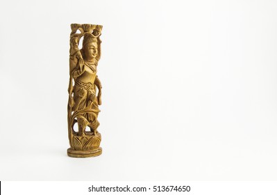 Indian goddess of happiness, luck and prosperity Lakshmi figurine from wood on white background