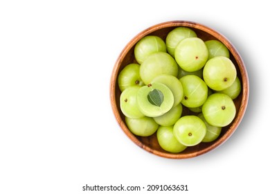 Indian gooseberry fruit (phyllanthus emblica, amla) in wooden bowl isolated on white background. Top view. Flat lay. Copy space.