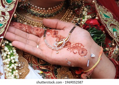 Indian Groom's Hand Holding Wedding Necklace In Hand At A Hindu Wedding. Henna Hand. 