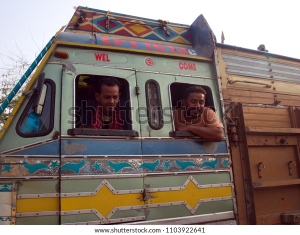 Indian Guy take action for a photo with a\
bus,Kolkata City, INDIA , 11th APRIL\
2013.