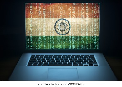 Indian hacker and computer expert. Laptop with binary computer code and India flag on the screen. Internet and network security.