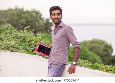 Indian Handsome Hipster Buisness Man In The City Holding Tablet