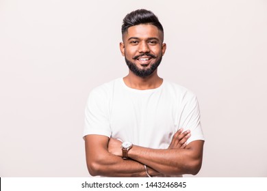 Indian Handsome Young Man Standing With Hands Folded Against White Background