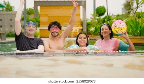 Indian happy extended family standing in swimming pool edge make fun joy look camera enjoy holiday trip resort park picnic. Smiling old senior parent with cute children spend day time outdoor together - Powered by Shutterstock