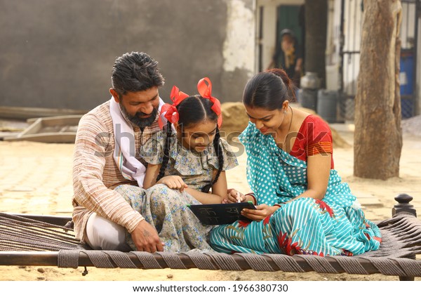 Indian Happy family\
studying with daughter