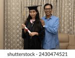 Indian Happy female graduation student with his father at home.  Indian proud parents. Concept of girl education. Happy fathers day. 