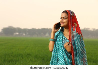 Indian happy female talking phone in village
