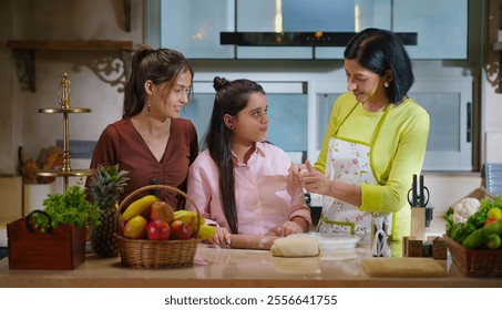 Indian happy mother with cute daughter rolling raw dough together teach baking cookies in modern kitchen house. Carefree young adult mom girl kid child learn cooking homemade bakery food indoor home - Powered by Shutterstock