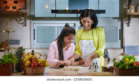 Indian happy mother with cute daughter rolling raw dough together teach baking cookies in modern kitchen house. Carefree young adult mom girl kid child learn cooking homemade bakery food indoor home - Powered by Shutterstock