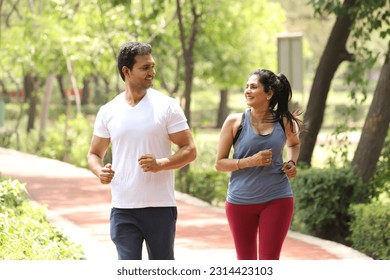 Indian happy people doing joking and running in park - Powered by Shutterstock